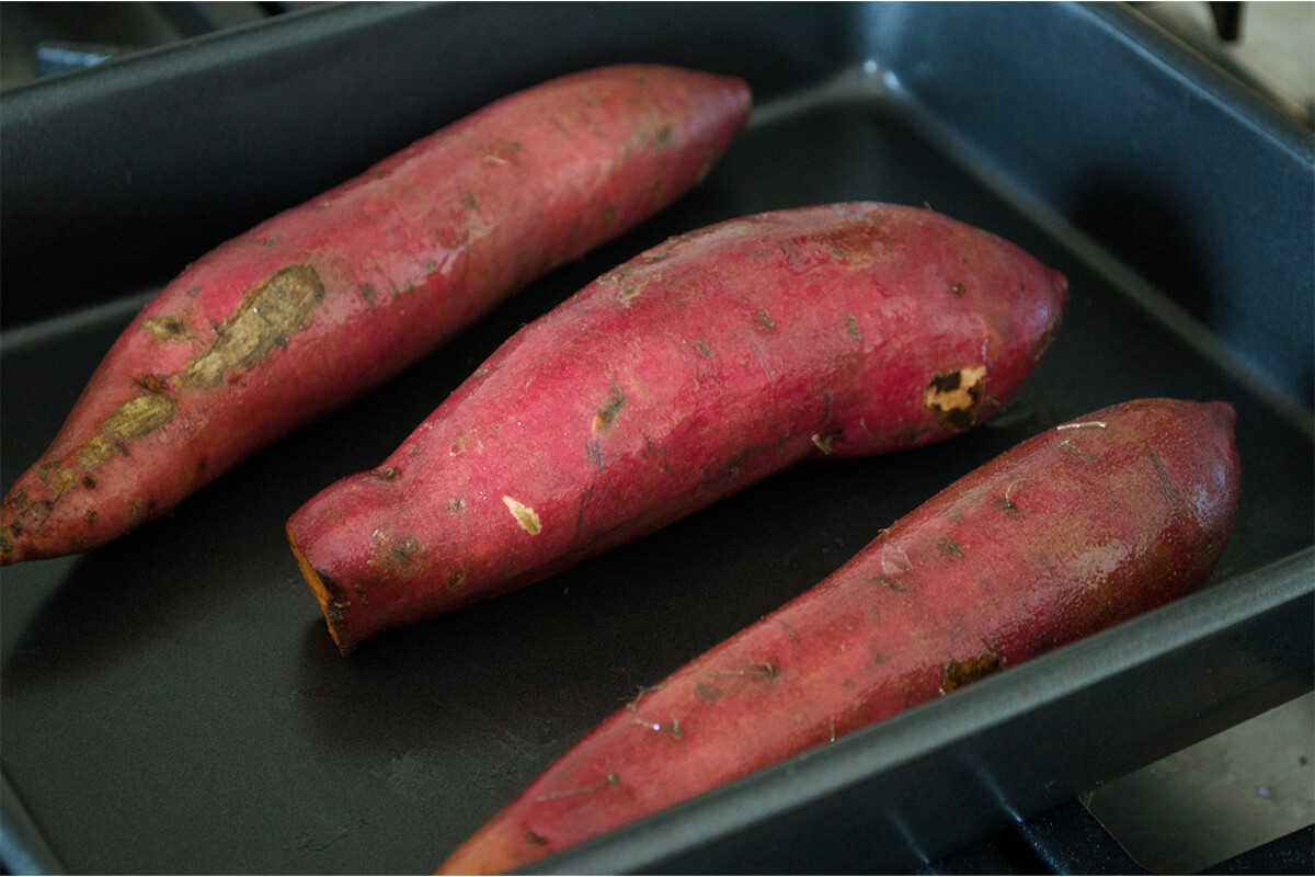 3 sweet potatoes on a baking tray