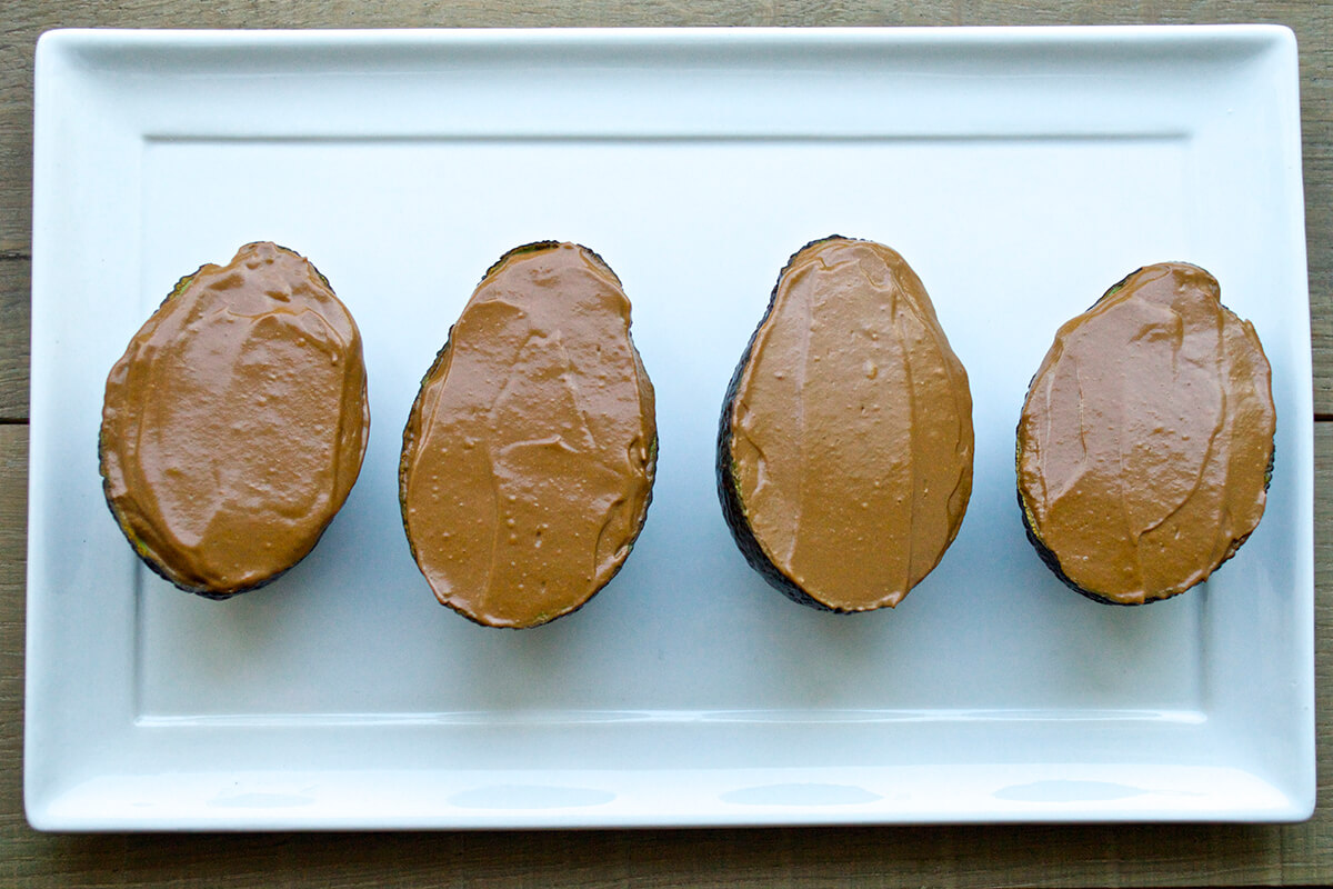 4 avocado shells filled with avocado chocolate orange mousse