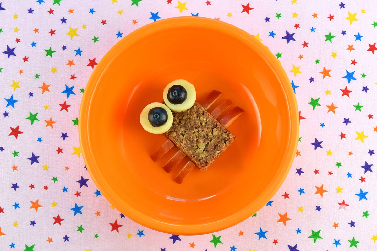 Two blueberry halves placed on apple circles to finish off the eyes