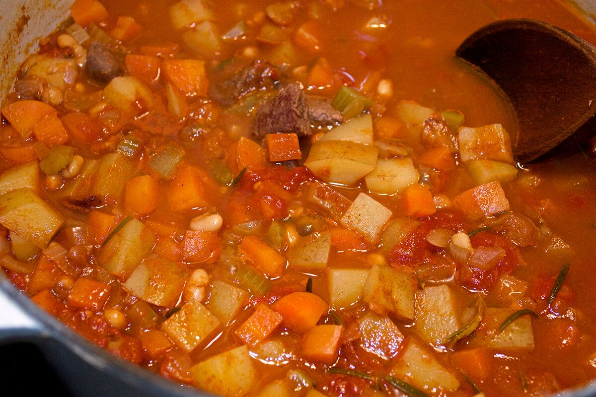 Baby Beef Stew with Apricots being cooked in saucepan