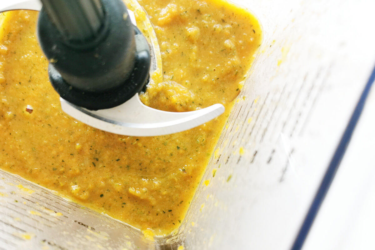 Pureed vegetables, carrots, sweet potato, spinach leaves, broccoli florets, and stock in a food processor 