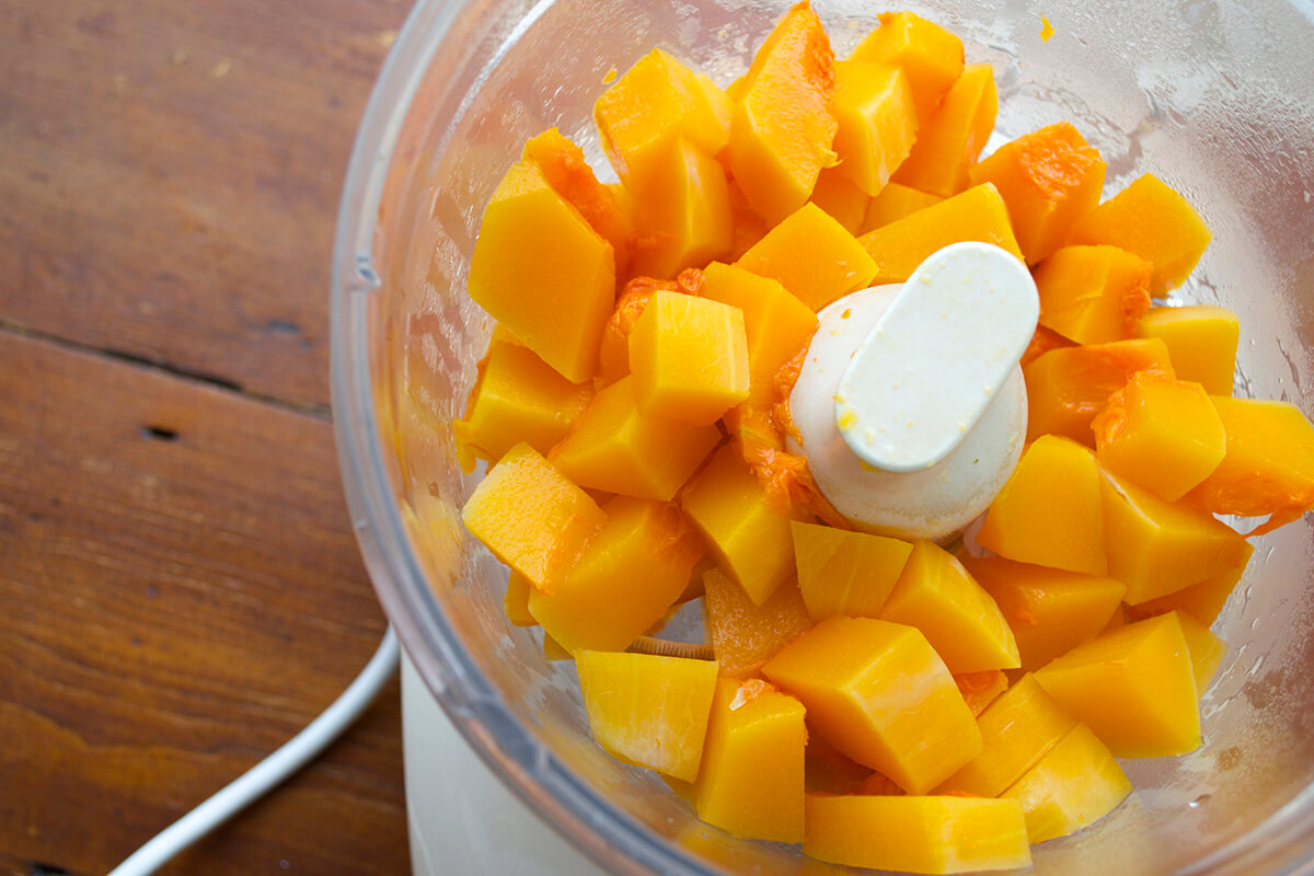 Cooked butternut squash in a food processor