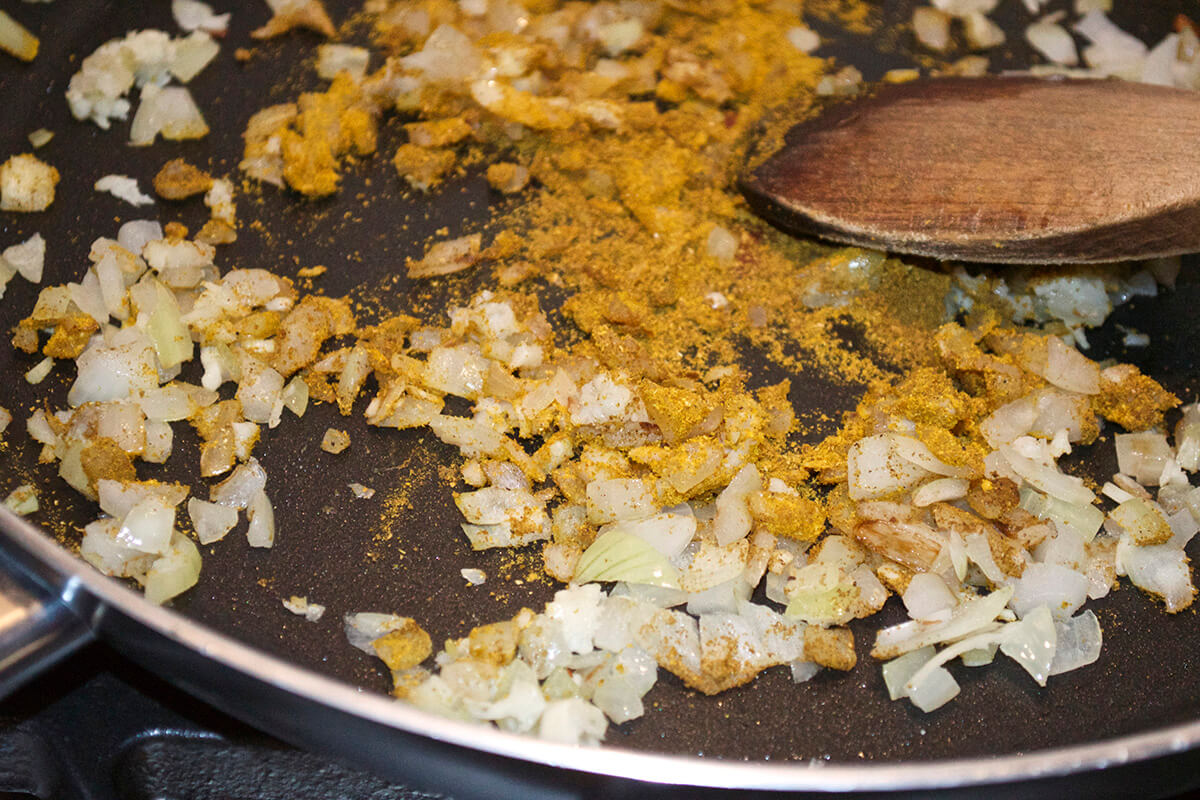 Onion and garlic being sauteed with spices