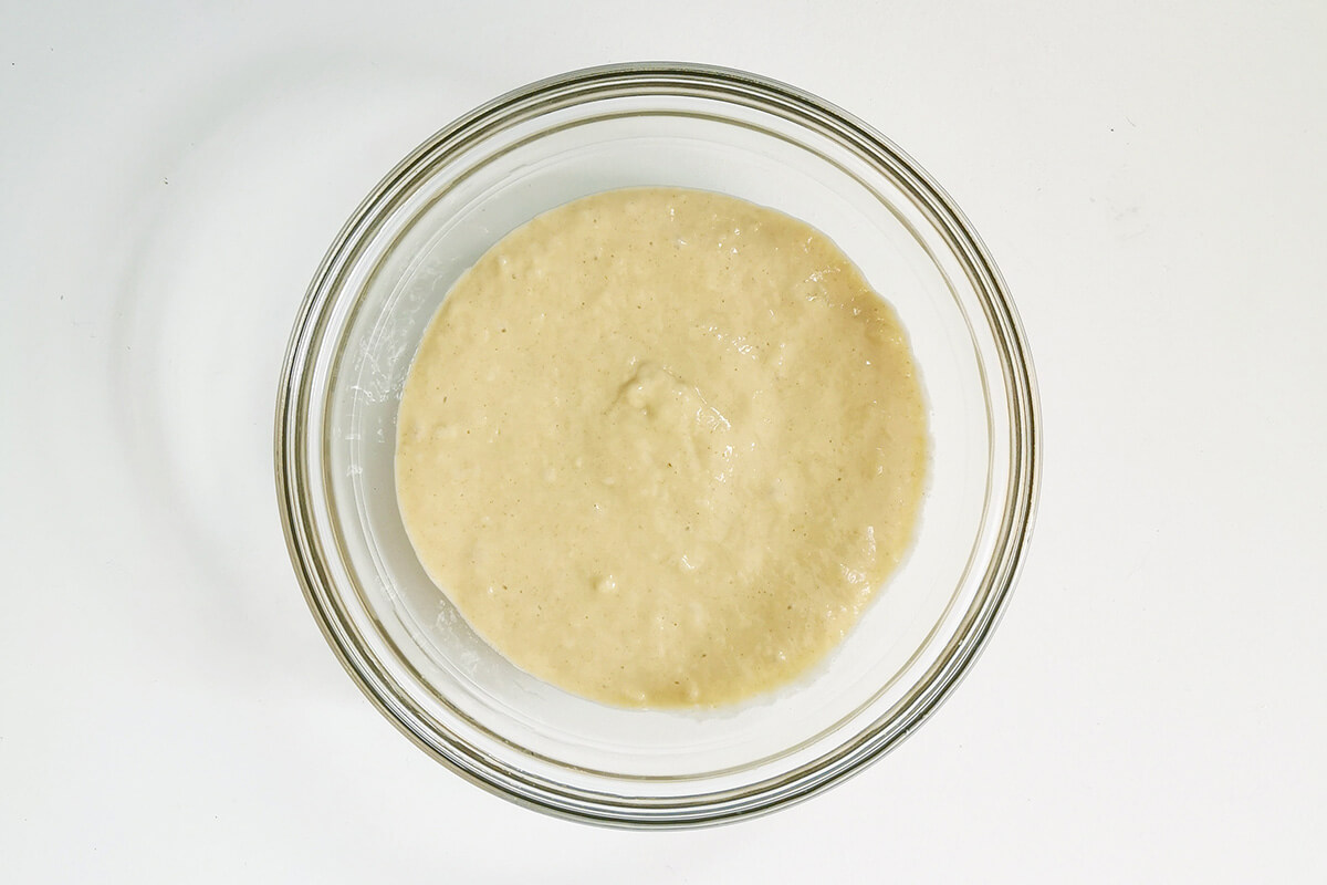 A glass bowl with cupcake batter