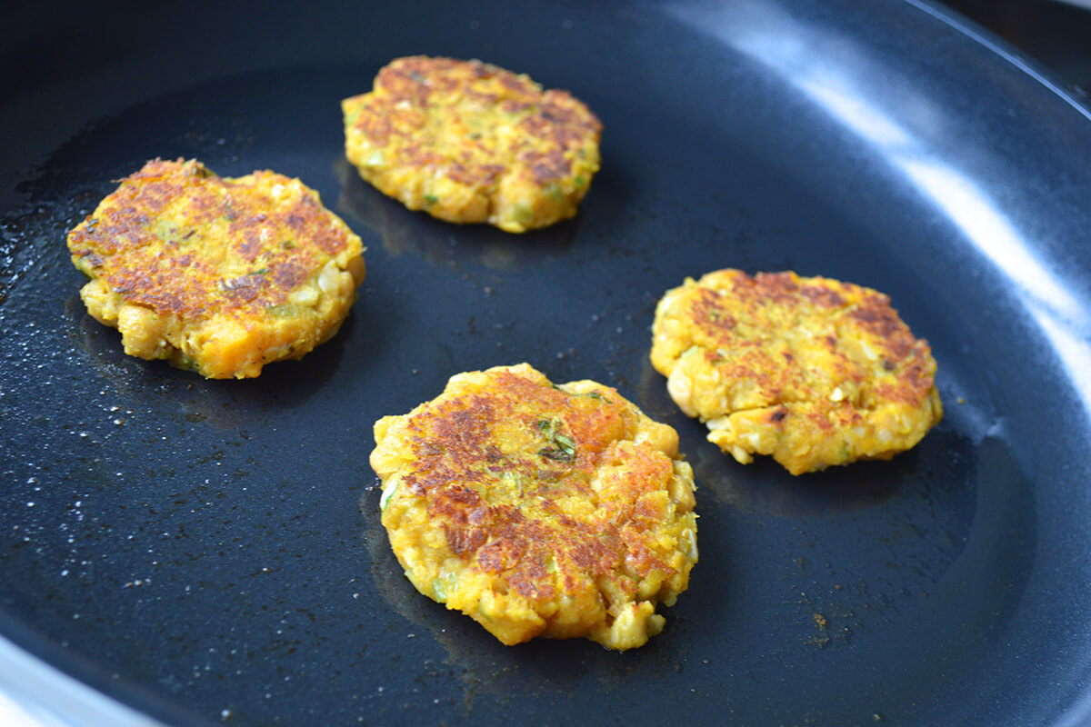 Patties being fried in a saucepan