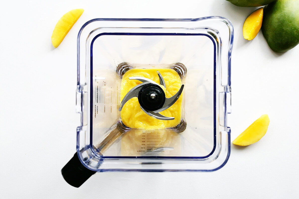 Mango cubes being blended in blender