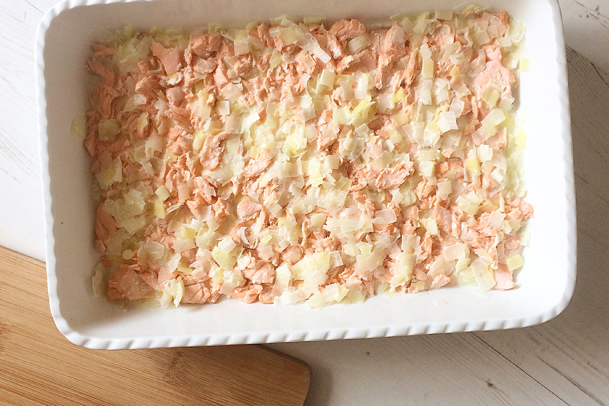 A casserole dish of the leek and salmon mix